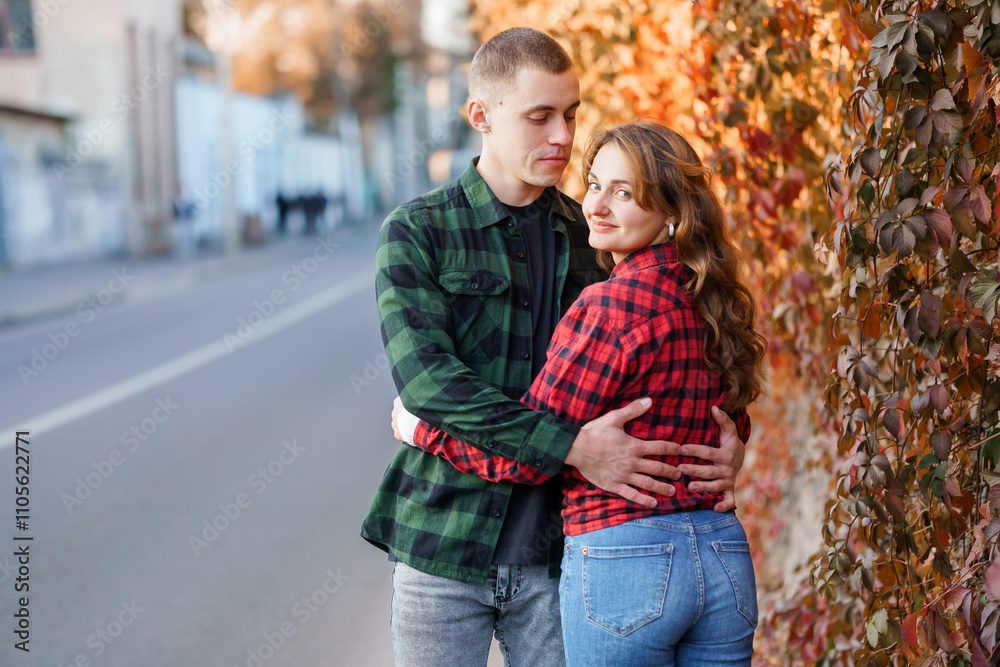 A Cozy Autumn Embrace: A Young Couple Enjoying Each Other's Company Amidst Fall Foliage A Cozy Autumn Embrace: A Young Couple Enjoying Each Other's Company Amidst Fall Foliage