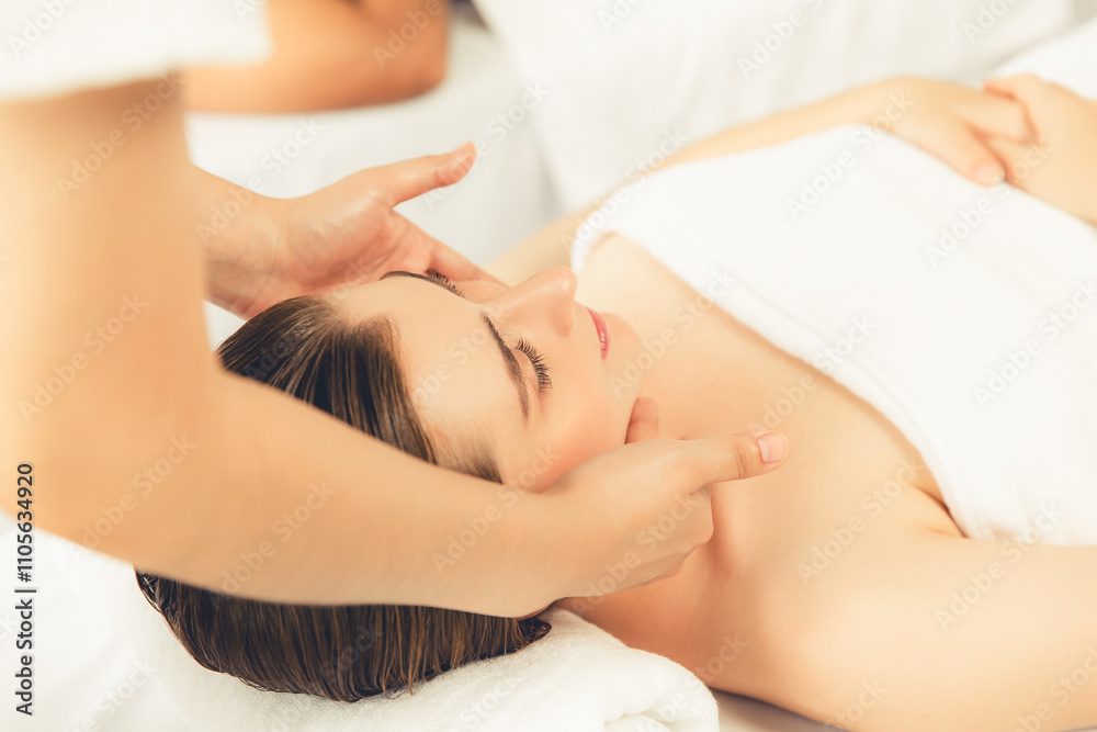Caucasian woman enjoying relaxing anti-stress head massage and pampering facial beauty skin recreation leisure in dayspa modern light ambient at luxury resort or hotel spa salon. Quiescent Caucasian woman enjoying relaxing anti-stress head massage and pampering facial beauty skin recreation leisure in dayspa modern light ambient at luxury resort or hotel spa salon. Quiescent