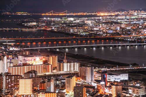 Highway and railway bridges crossing the Yodo River, night skyline, Osaka, Honshu, Japan