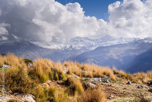 Dreamy mountain landscapes of Sierra Nevada Mulhacen, Alcazaba, Pico del Veleta wth snowy peaks, and golden dry alpine grassland, Granada, Andalusia, Spain photo