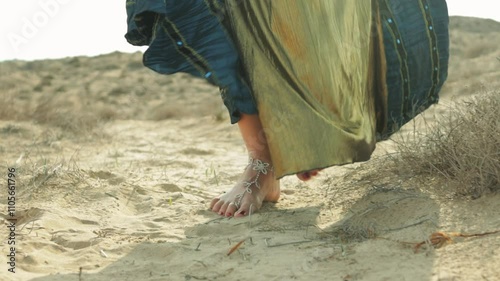 Belly Dancer in Stunning Blue and Gold Dress Walk Barefoot on Warm Sand, Showcasing Elegance and Grace. Performance Reflects Rich Cultural Traditions and Beauty of Movement