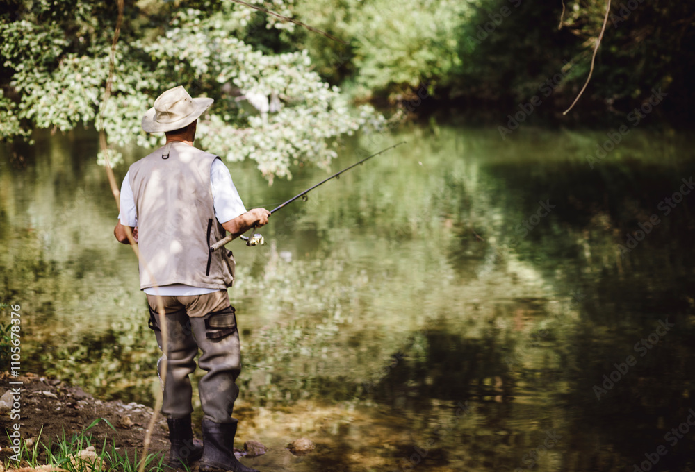 A fisherman standing by a calm river, wearing a fishing vest and hat, holding a fishing rod surrounded by lush green nature. A fisherman standing by a calm river, wearing a fishing vest and hat, holding a fishing rod surrounded by lush green nature.