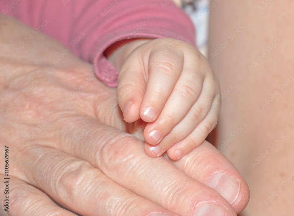 Mother holding hand of newborn. Child's hand. Newborn baby holding mother's hand close-up. Mother holding hand of newborn. Child's hand. Newborn baby holding mother's hand close-up.