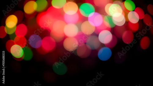 Abstract colorful bokeh with vivid red, green, and blue lights floating on a black grad