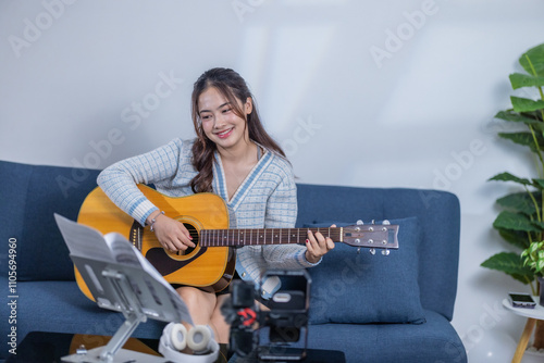 Woman Practicing Acoustic Guitar at Home