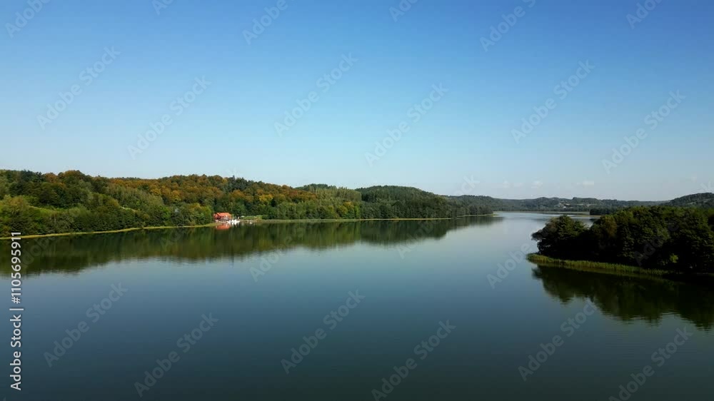 The Brodno Wielkie lake, flying film shot above the water surface. Aerial view, Kashubia district, Poland. The Brodno Wielkie lake, flying film shot above the water surface. Aerial view, Kashubia district, Poland.