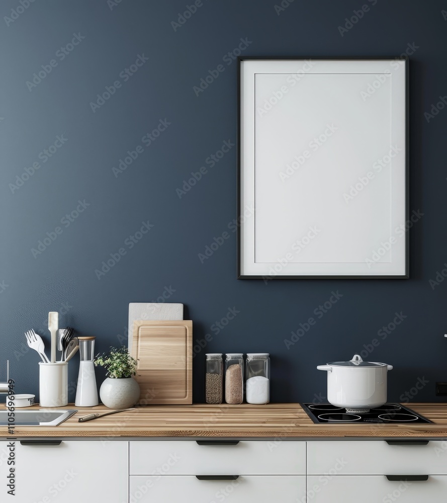A blank picture frame hanging on a dark blue wall in a kitchen with a wood countertop and white cabinets A blank picture frame hanging on a dark blue wall in a kitchen with a wood countertop and white cabinets