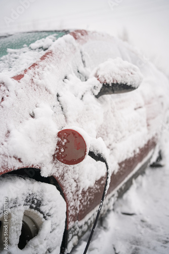 Red Electric Car Charging in the Snow
