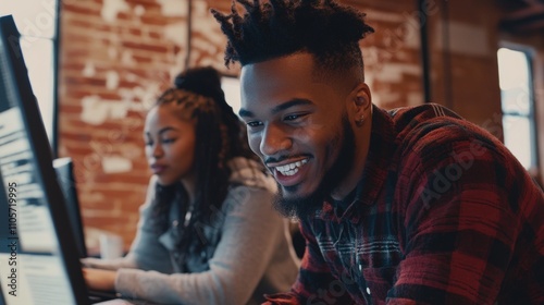 Young african adult male and female enjoy collaborative work in a cozy office setting.