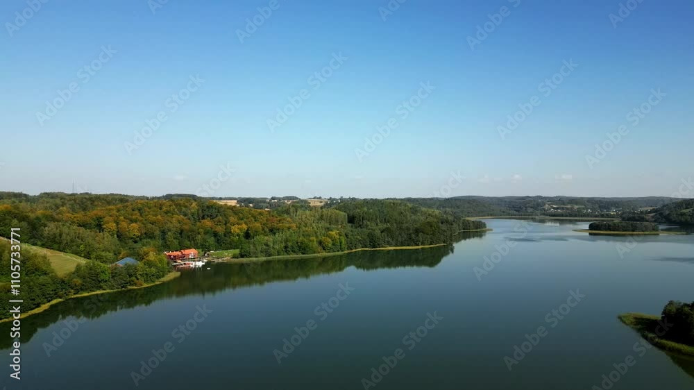 The Brodno Wielkie lake and a small boat house.Aerial view, Kashubia district, Poland. The Brodno Wielkie lake and a small boat house.Aerial view, Kashubia district, Poland.
