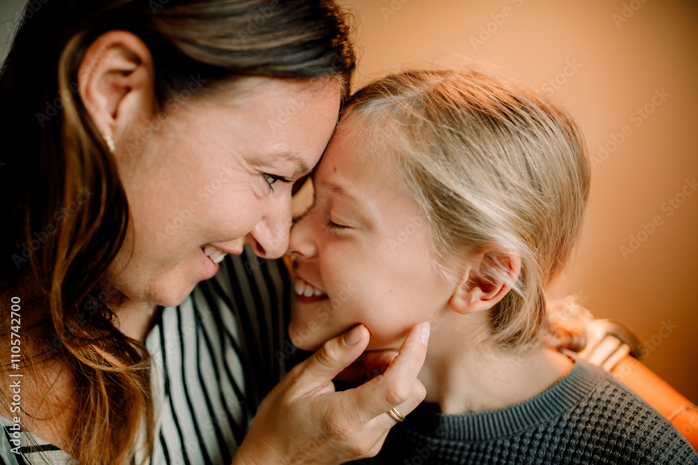 Smiling mother rubbing nose with son at home Smiling mother rubbing nose with son at home