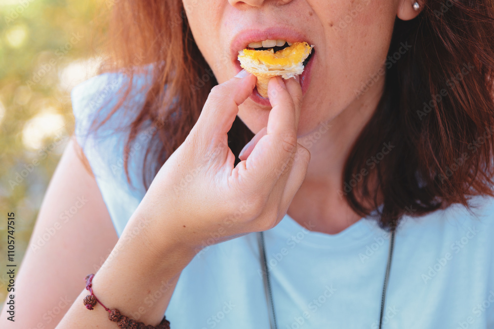 Woman enjoying a delicious pastry, capturing the moment of taste and enjoyment. Woman enjoying a delicious pastry, capturing the moment of taste and enjoyment.