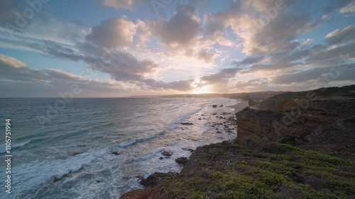 Waves breaking against volcanic rock formations at sunset on the south coast of Australia.