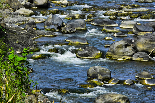 Beautiful, aesthetic and artistic river rocks with clear water in rural Asia Indonesia 