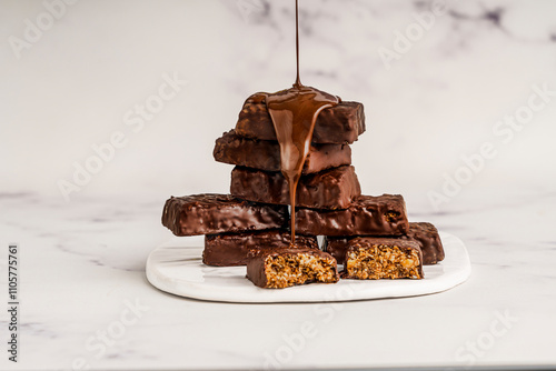 Chocolate covered granola bites on a light background