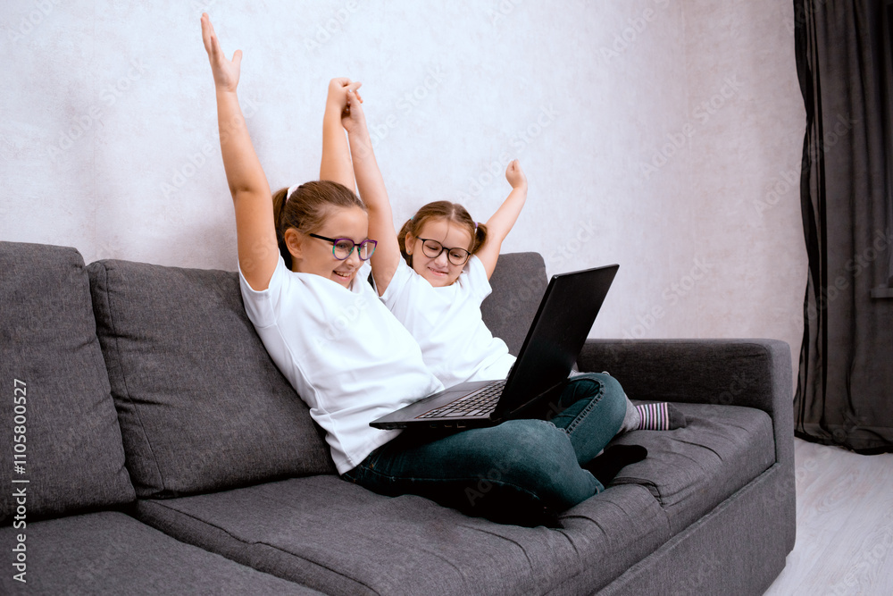 Two little sisters, of preschool age, do their homework online using modern technology. Perfect for themes about online learning, child development, and technology. Two little sisters, of preschool age, do their homework online using modern technology. Perfect for themes about online learning, child development, and technology.