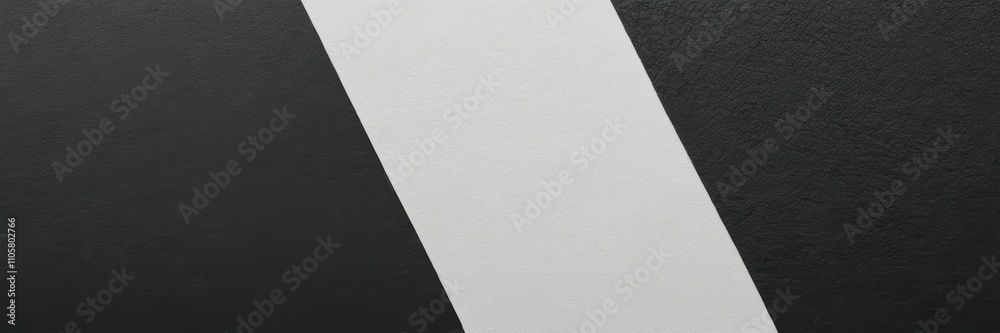 a close-up of a surface with a black background and a wide white diagonal stripe running across it. The texture of the surface appears to be smooth. a close-up of a surface with a black background and a wide white diagonal stripe running across it. The texture of the surface appears to be smooth.