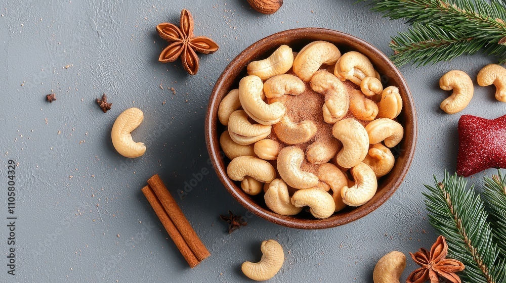 A Bowl of Cashew Nuts Surrounded by Festive Decorations and Spices on a Gray Surface, Perfect for Holiday Snacking and Healthy Eating Inspiration A Bowl of Cashew Nuts Surrounded by Festive Decorations and Spices on a Gray Surface, Perfect for Holiday Snacking and Healthy Eating Inspiration