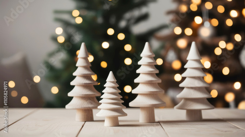 Minimalist wooden Christmas trees on a table with festive bokeh in the background