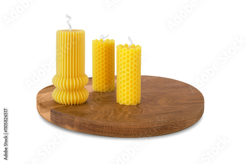 Group of three beeswax candles on wooden tray isolated on white background. Healthy product, aromatherapy