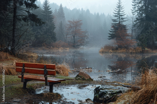 peaceful and melancholic autumn landscape. Bench by the water..  photo