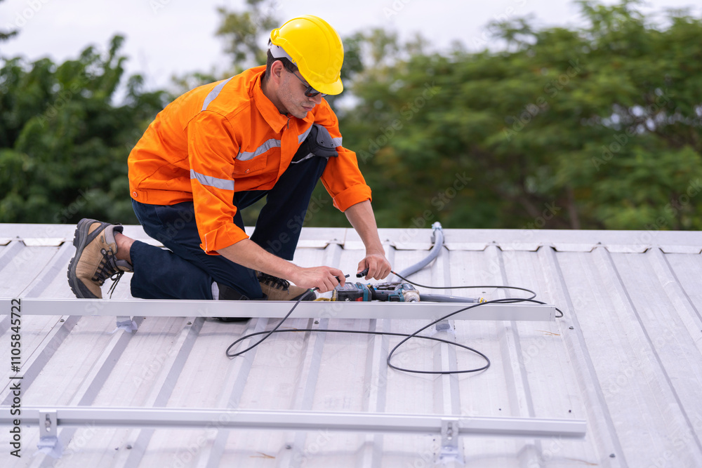 Technician in an orange safety uniform and helmet handling an electrical cable on a rooftop. Represents safety, professionalism, and expertise in renewable energy installations and maintenance work.