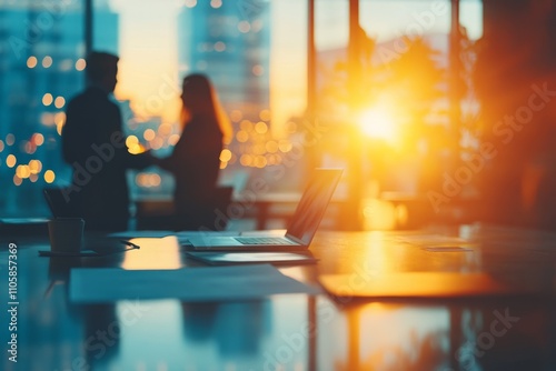 Wallpaper Mural Business partners shaking hands in a modern office at sunset, with a laptop and documents on the desk in the foreground Torontodigital.ca