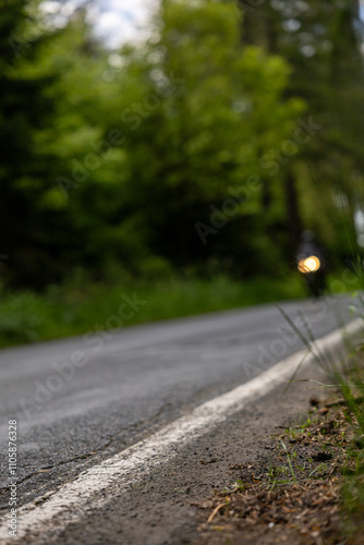 Country road in Bergisches Land Germany with blurry motorbike in the background