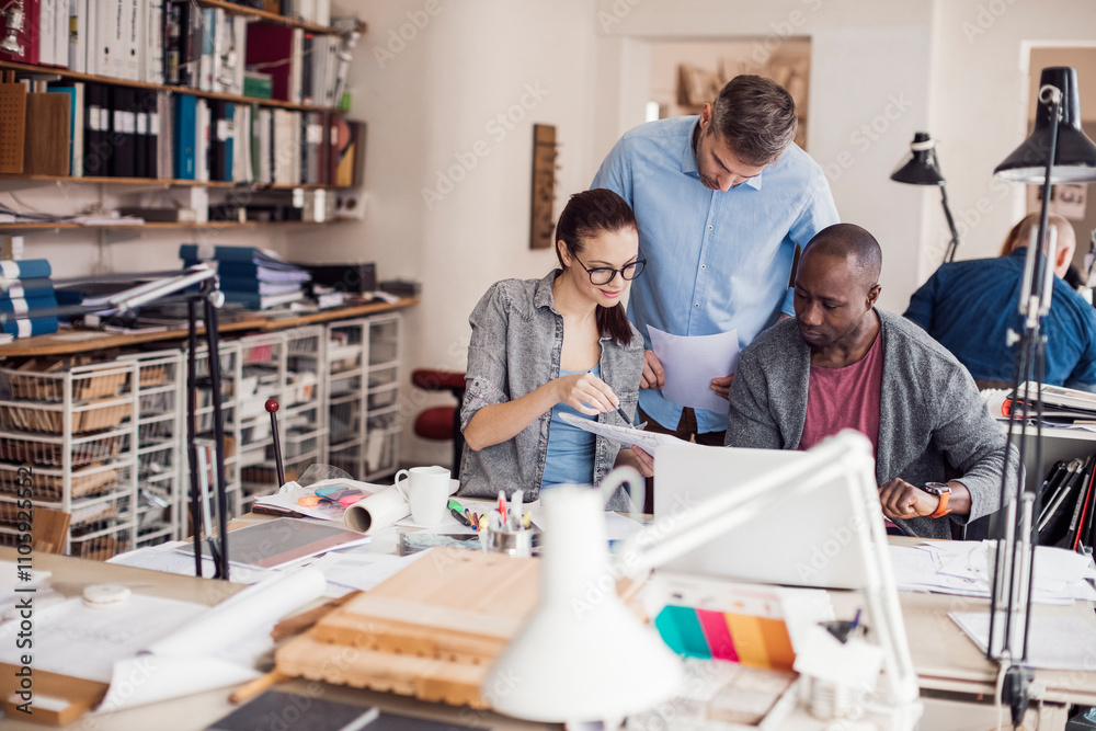 Group of people working together on a project in a startup company office Group of people working together on a project in a startup company office