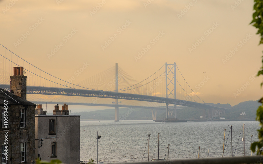 Obraz premium The Forth Road and Queensferry Crossing bridges span the the Firth of Forth west of central Edinburgh.