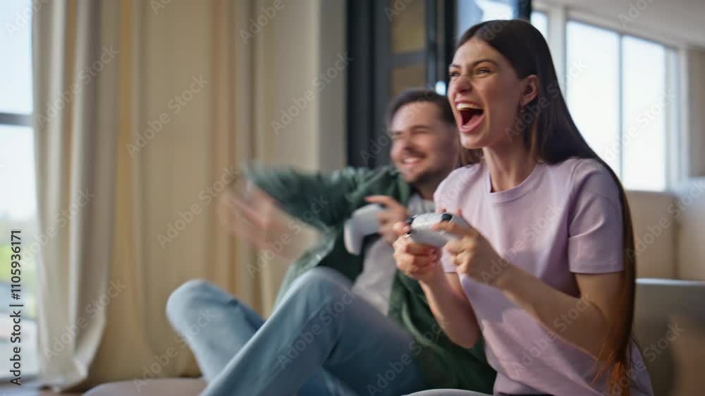 Friends playing video game enjoying online competition at apartment closeup Friends playing video game enjoying online competition at apartment closeup