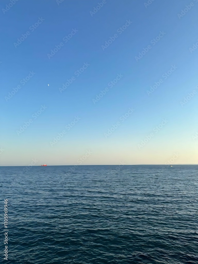 Ocean view with clear blue sky and distant ships. Ocean view with clear blue sky and distant ships.