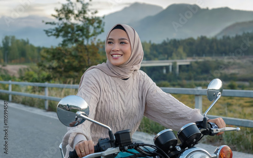 Wallpaper Mural beautiful Asian woman wearing a hijab and a sweater riding a motorcycle Torontodigital.ca