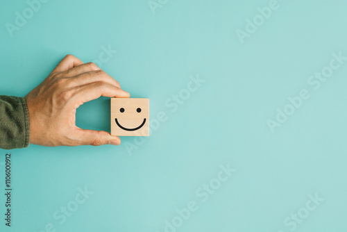 Service rating, satisfaction and positive feedback concept. Customer show smile face emoticon for rating indicates the highest level of satisfaction with the service