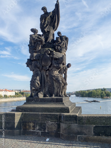 Statue at Charles Bridge, Prague, a historic bridge that crosses the Vltava river, Czech Republic photo