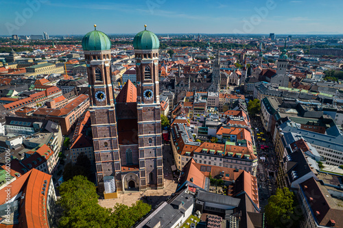 Beautiful aerial footage of Marienplatz the magestic New Town Hall, its clock and the Frauenkirche gothic church in the City of Munich Babaria Germany photo