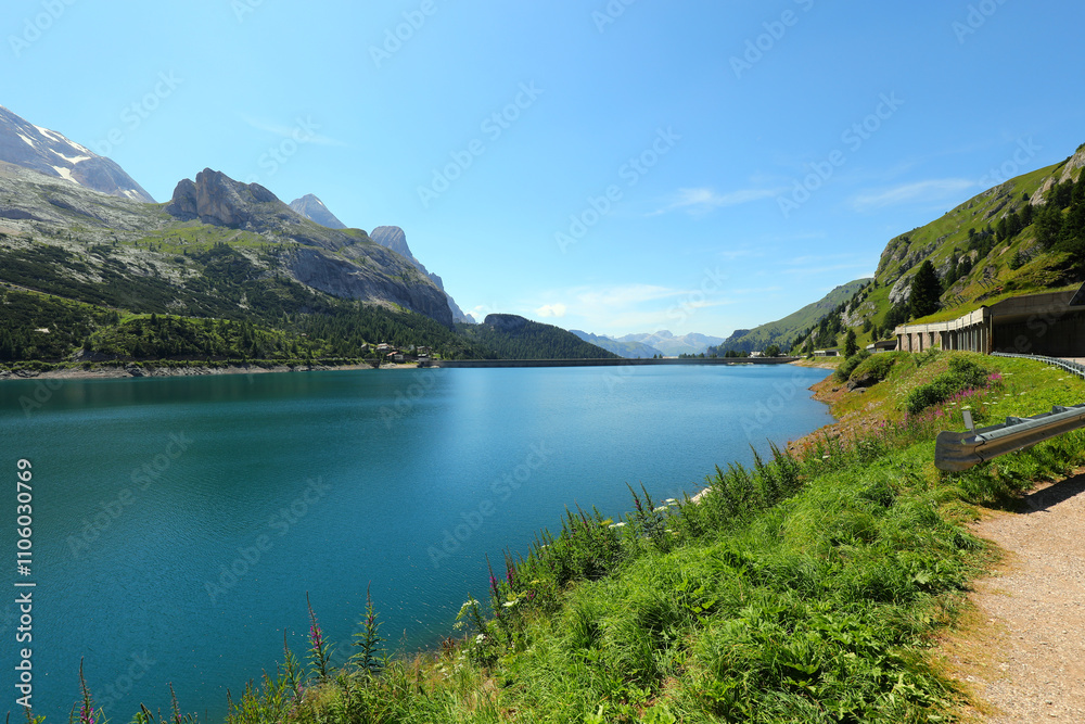 Alpine panorama with FEDAIA lake fed by the melting snow of the Marmolada glacier in Italy Alpine panorama with FEDAIA lake fed by the melting snow of the Marmolada glacier in Italy