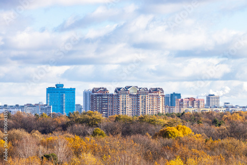 blue cloudy sky over colorful city park and houses photo