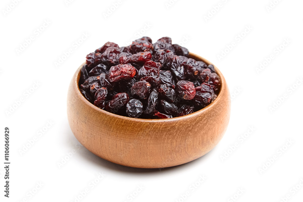 A wooden bowl filled with dried cranberries showcasing rich red tones and wrinkled textures. Perfect for healthy snacks or culinary recipes A wooden bowl filled with dried cranberries showcasing rich red tones and wrinkled textures. Perfect for healthy snacks or culinary recipes
