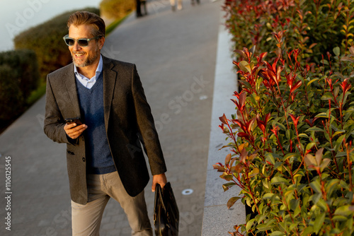 Man in a stylish blazer enj...