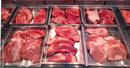 Butcher shop fridge counter with cold raw meat