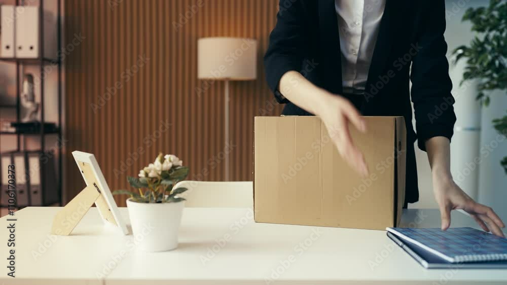 Close-up of office worker packing her items after getting fired, exiting her job