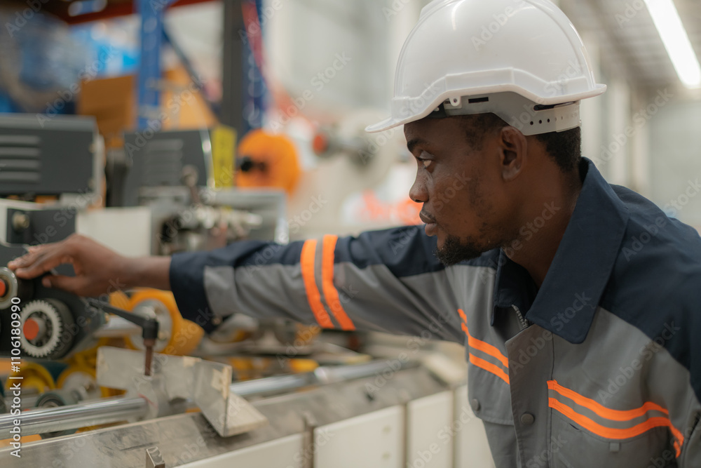 Focused worker adjusting machinery settings. Focused worker adjusting machinery settings.