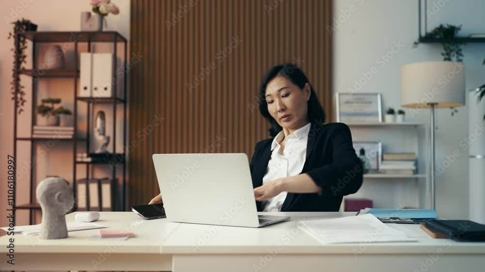 Time-lapse of a busy middle-aged Asian businesswoman working in office all day