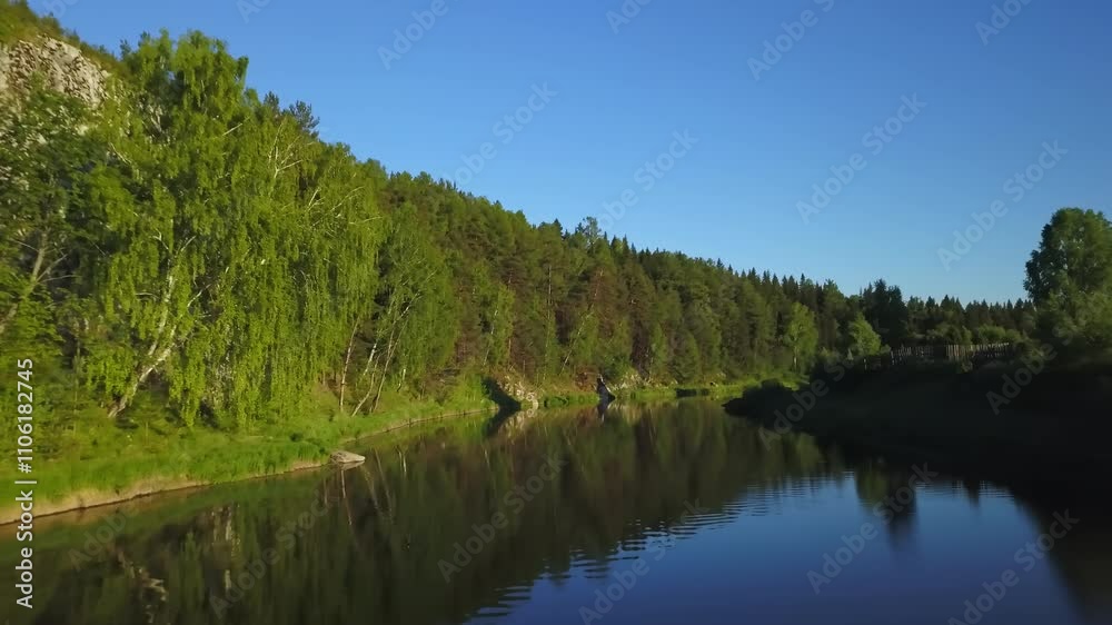 A serene and tranquil river flows gently through a lush, vibrant forest landscape. Stock Clip A serene and tranquil river flows gently through a lush, vibrant forest landscape. Stock Clip