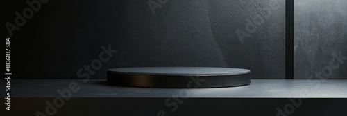 Minimalistic black display stand with soft lighting against a textured dark wall
