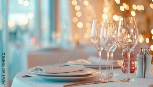 Elegantly designed table setting with sparkling wine and floral arrangement f...