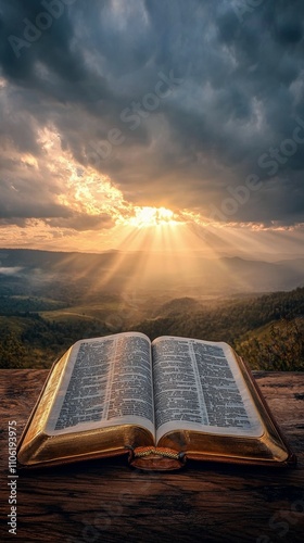 Sunlight breaks through clouds over an open book with scenic landscape in the...