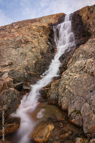 Beautiful waterfall in the Qalerallit fjord and glacier (South of Greenland) photo