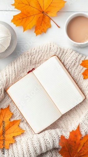 Cozy autumn atmosphere with open notebook and colorful leaves on soft gray bl...